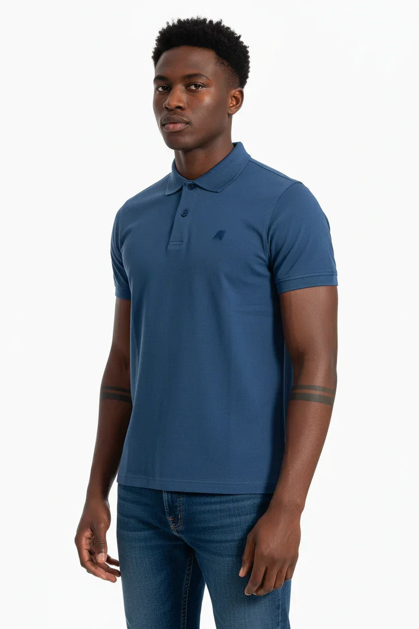 Modello indossa polo uomo blu a maniche corte e jeans, moda casual elegante