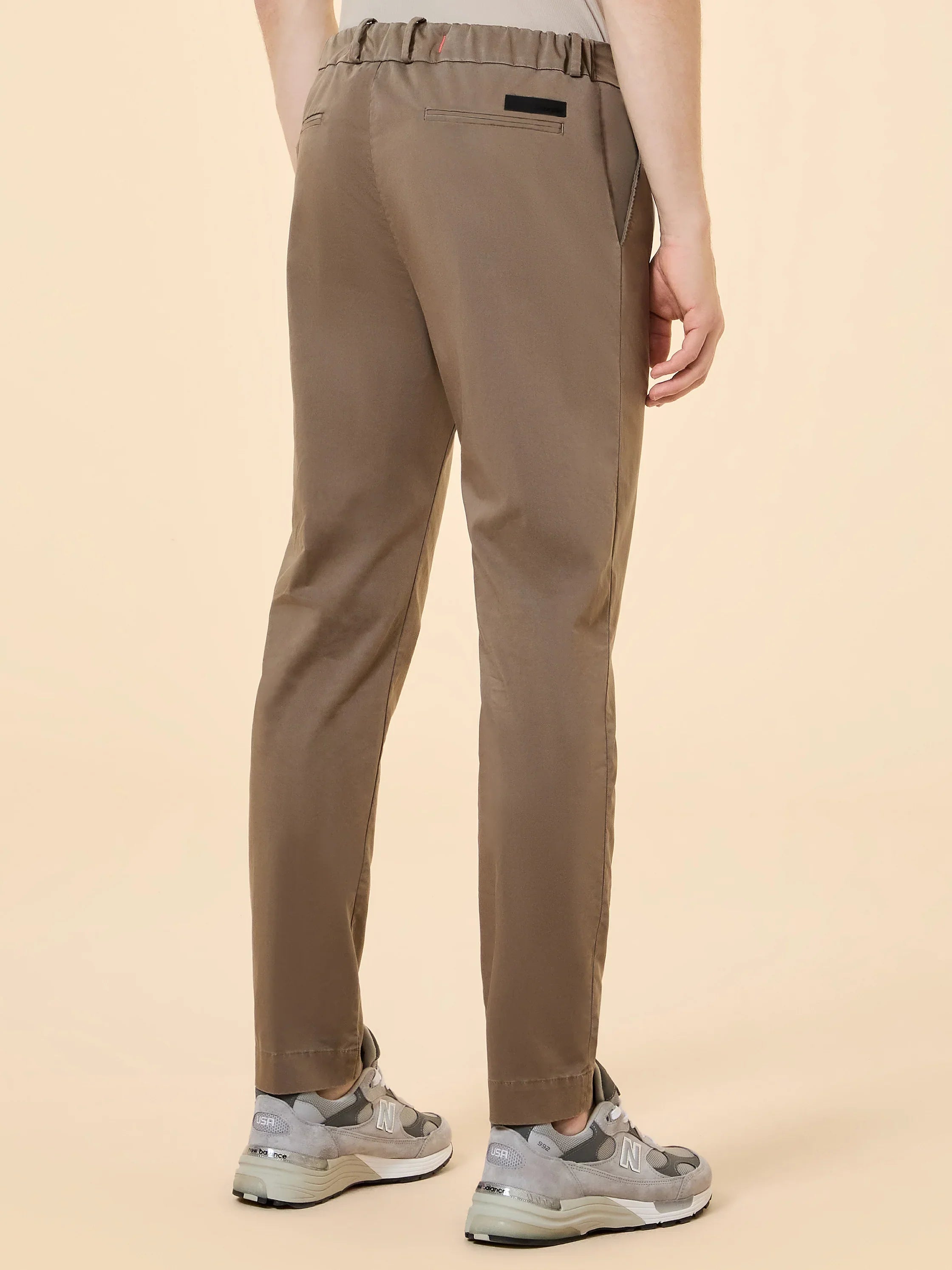 Pantaloni uomo beige con elastico in vita, tasche posteriori, indossati da modello