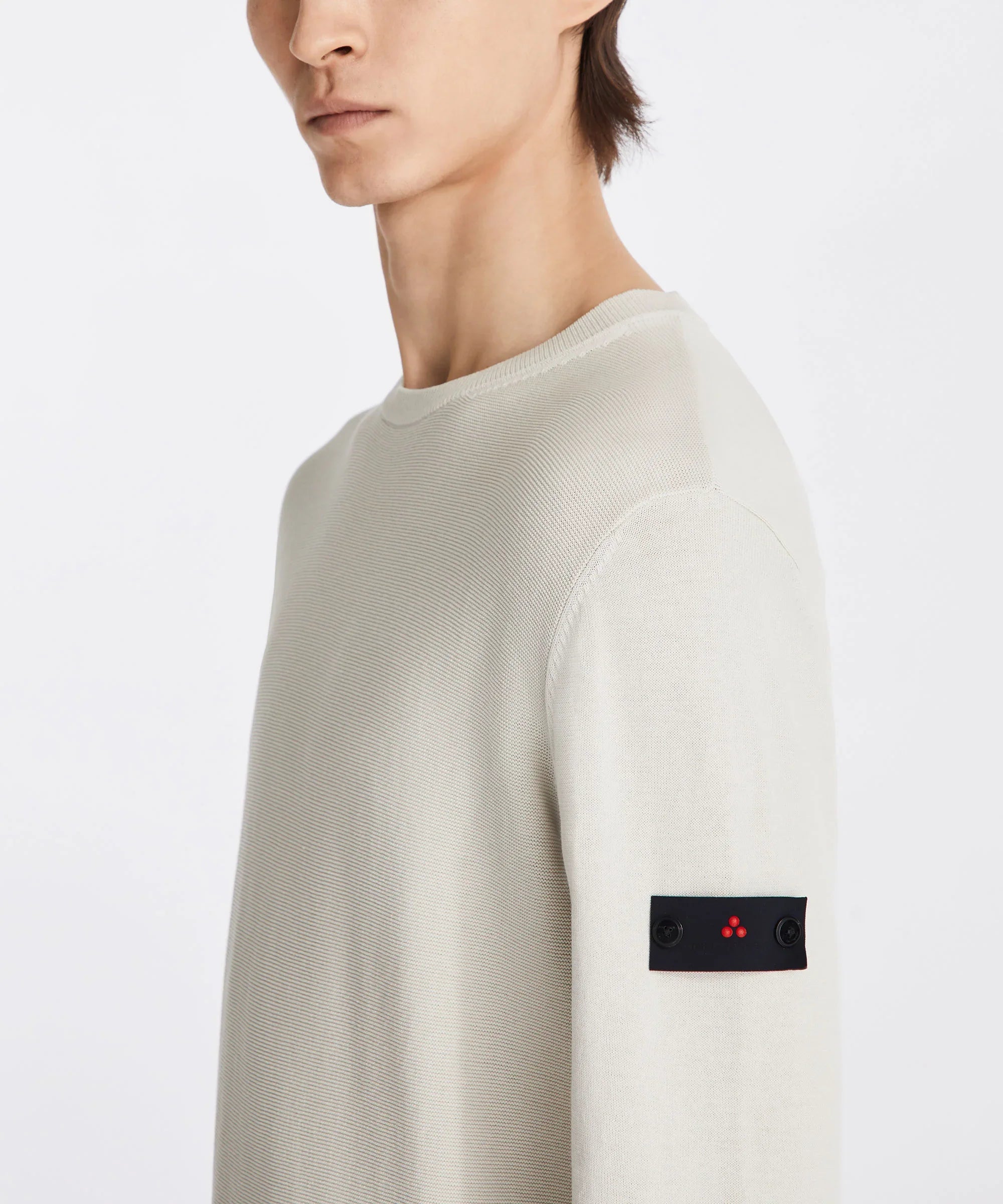 Maglia uomo beige chiaro con patch nera e dettaglio rosso sulla manica, stile casual