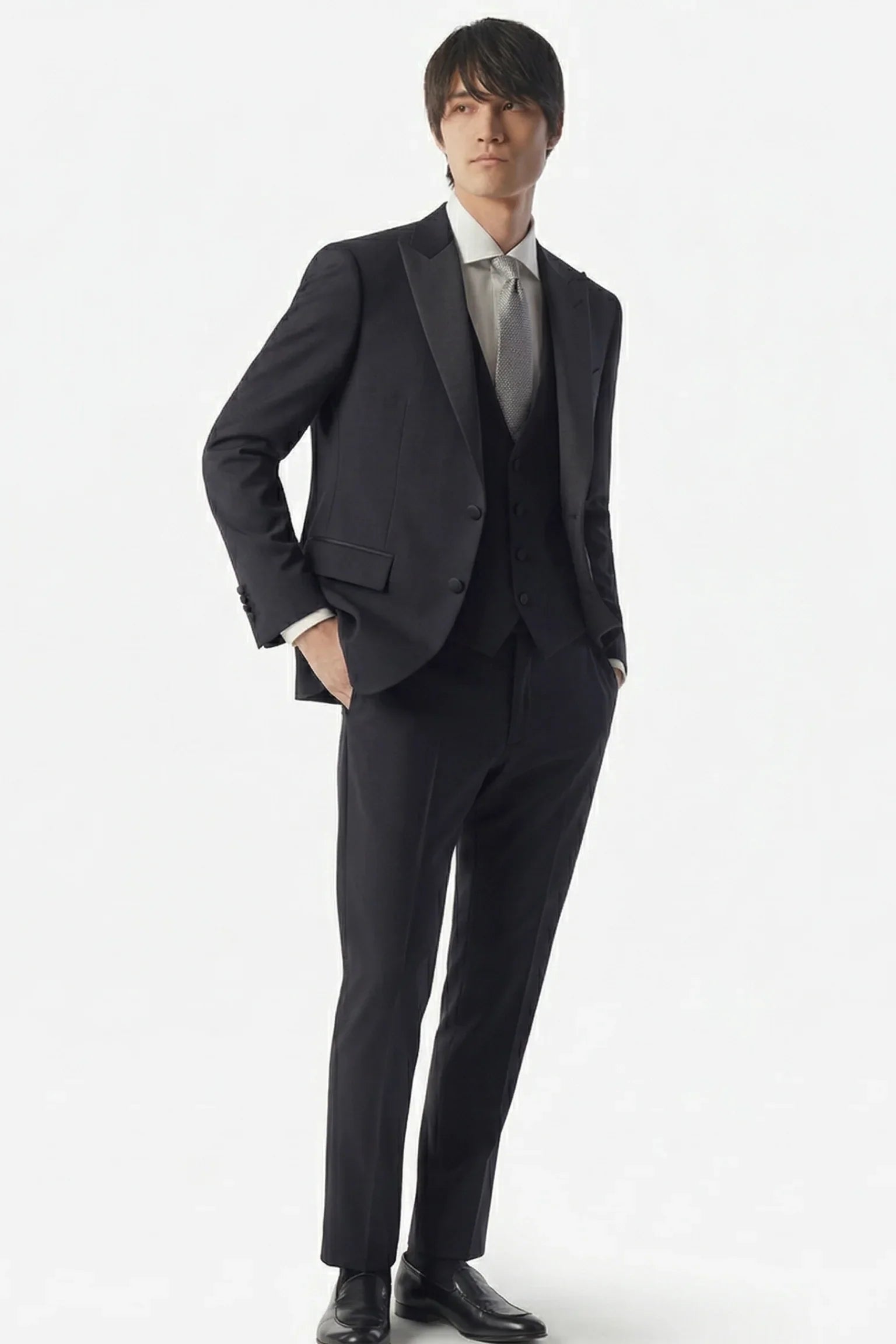 Uomo con abito elegante nero, camicia bianca e cravatta grigia, moda uomo formale