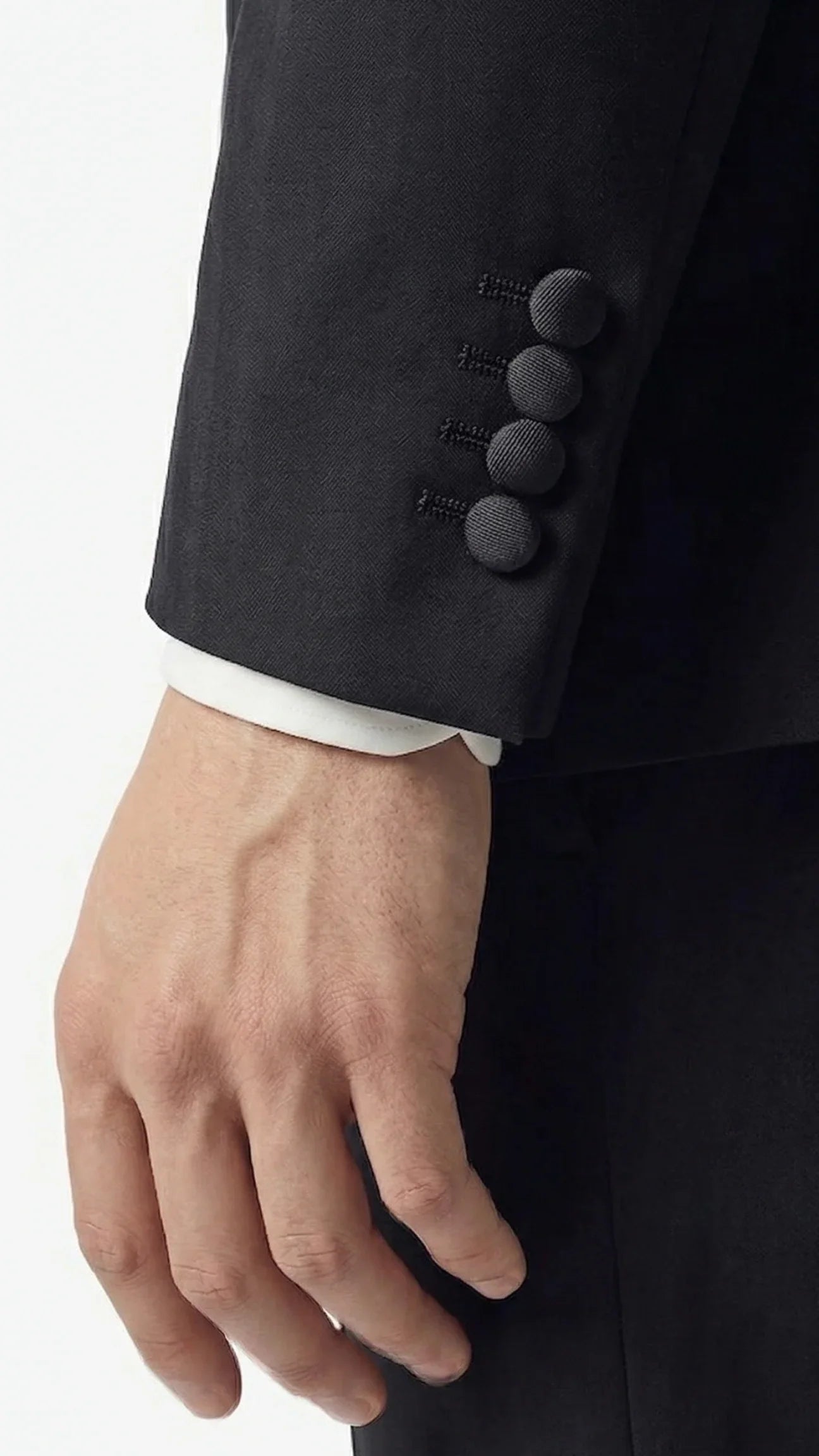 Dettaglio polsino giacca uomo elegante nera con bottoni, abbigliamento sartoriale