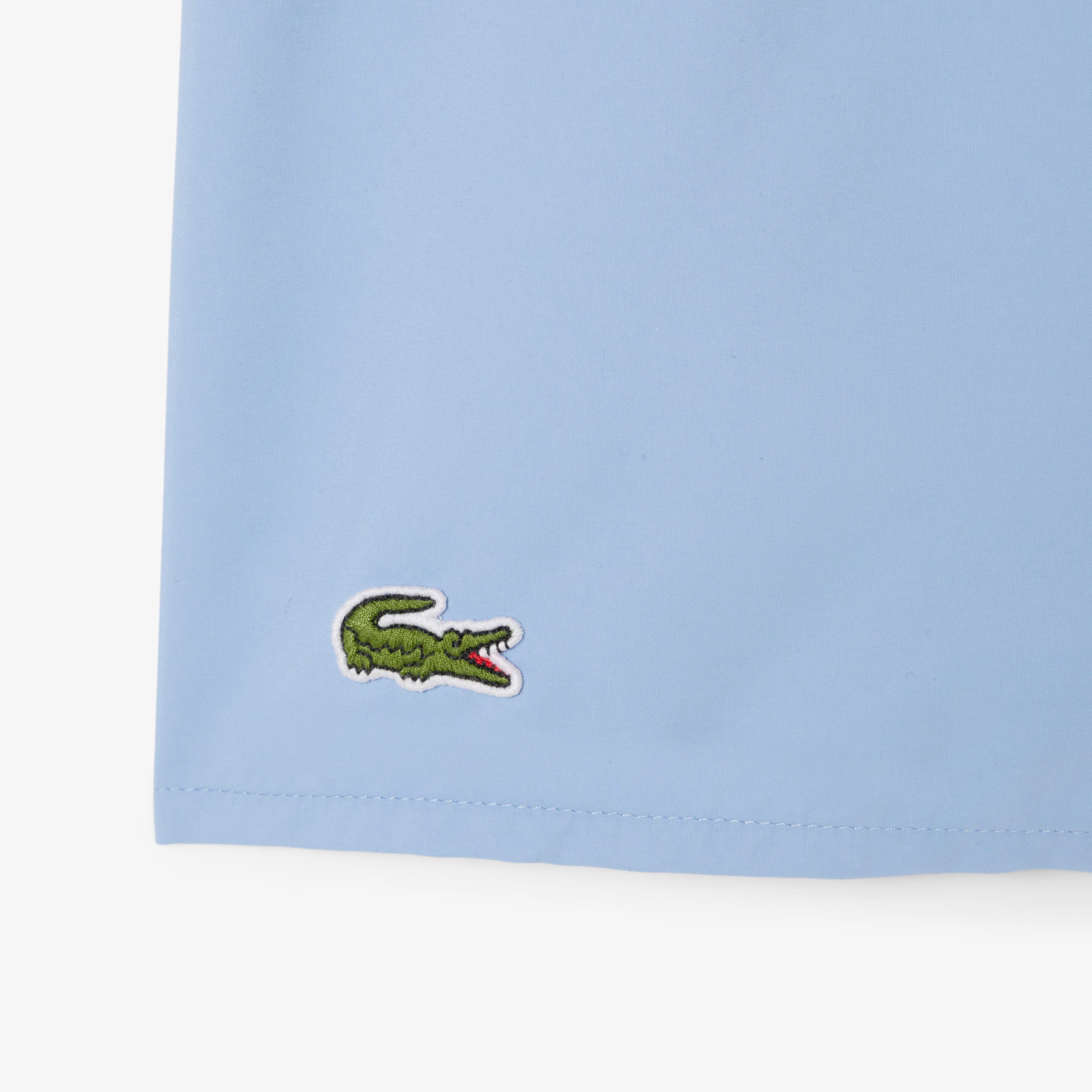 Costume da bagno LACOSTE MH6270 38I in tessuto quick-dry con motivo a tinta unita, ideale per nuoto e sport acquatici.