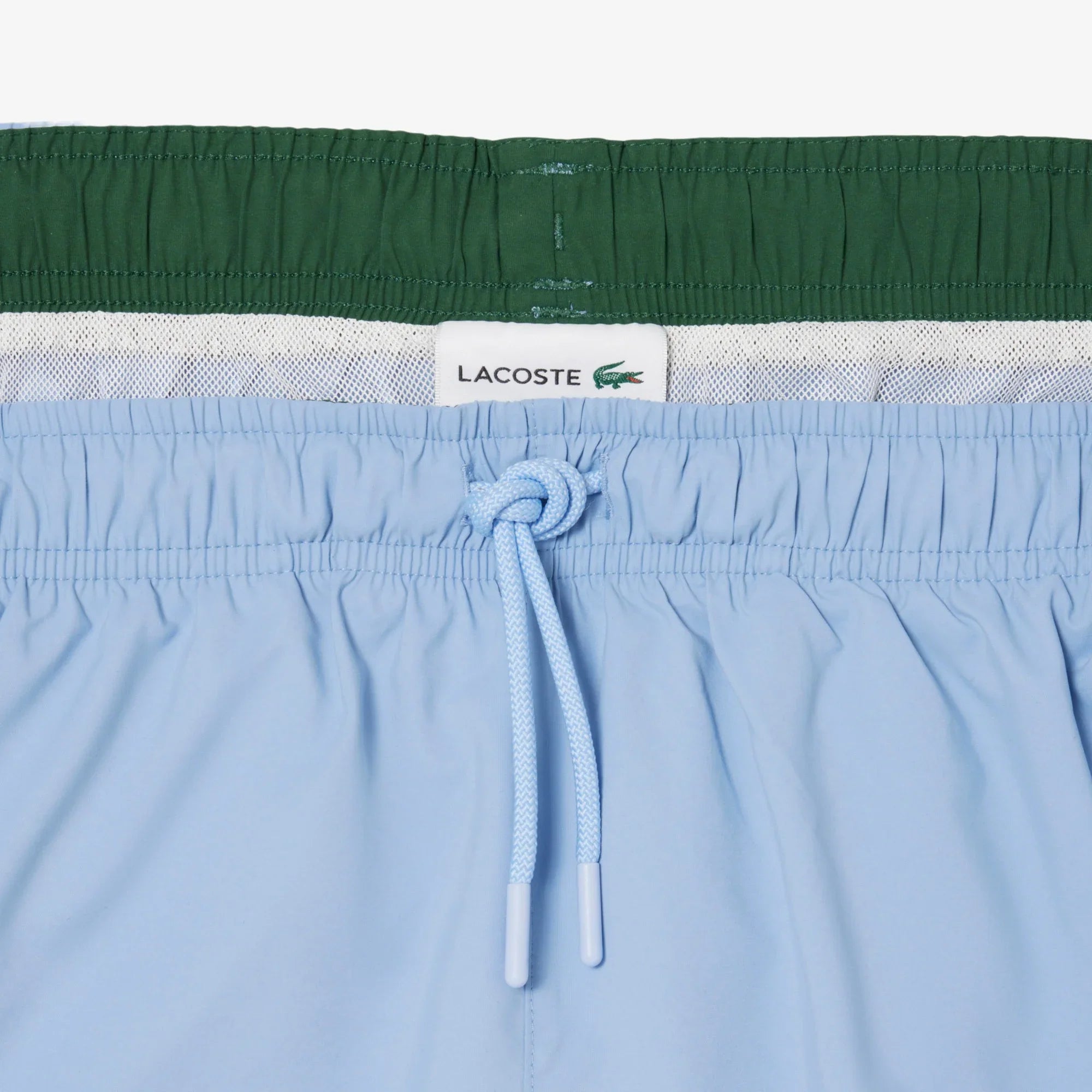 Costume uomo azzurro con coulisse e fascia elastica, dettaglio interno retinato verde.