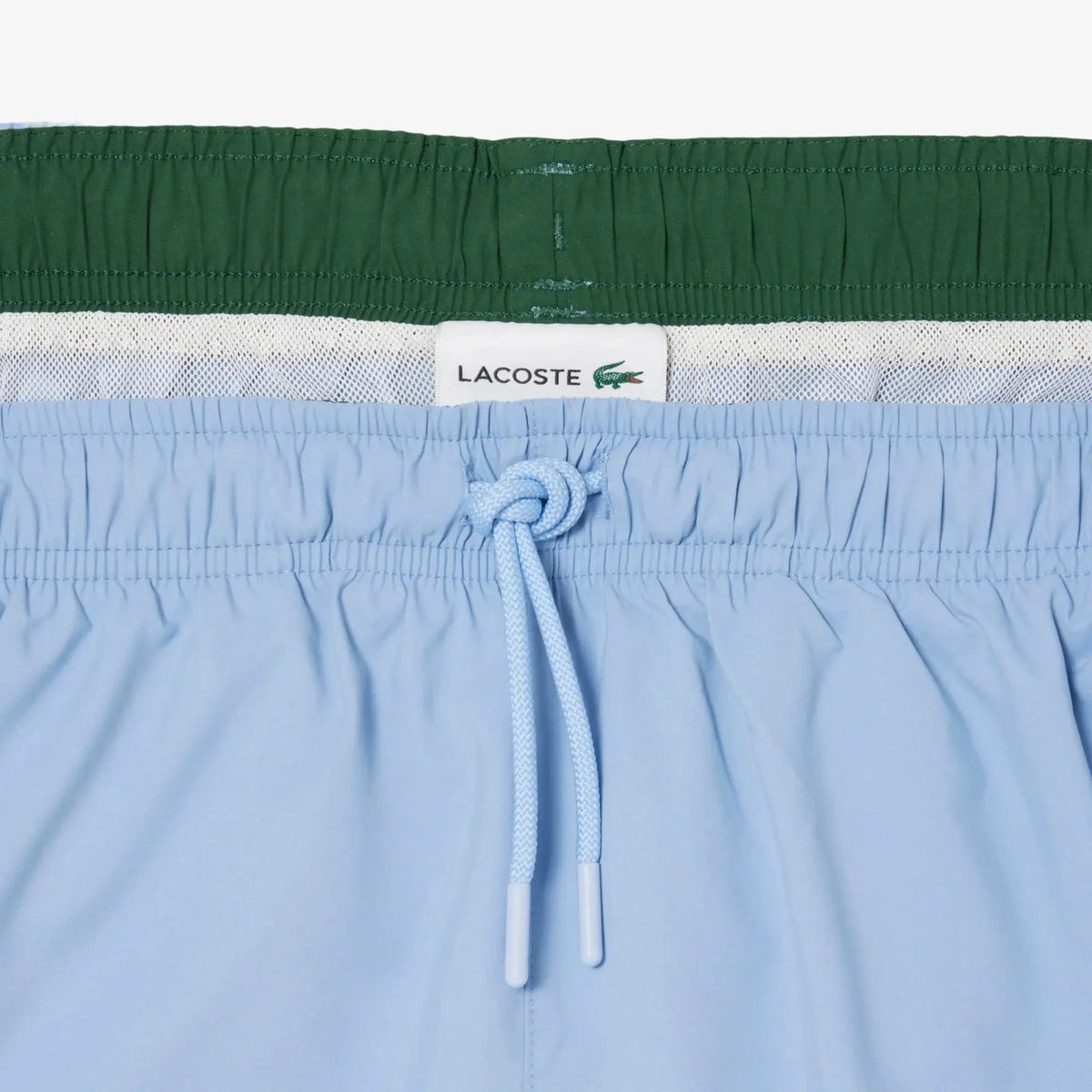 Costume uomo azzurro con coulisse e fascia elastica, dettaglio interno retinato verde.