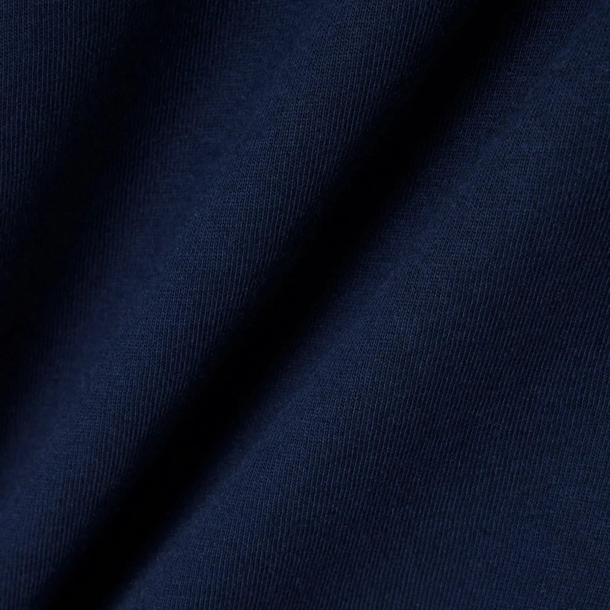 Dettaglio tessuto blu scuro, texture abbigliamento uomo donna, moda Made in Italy