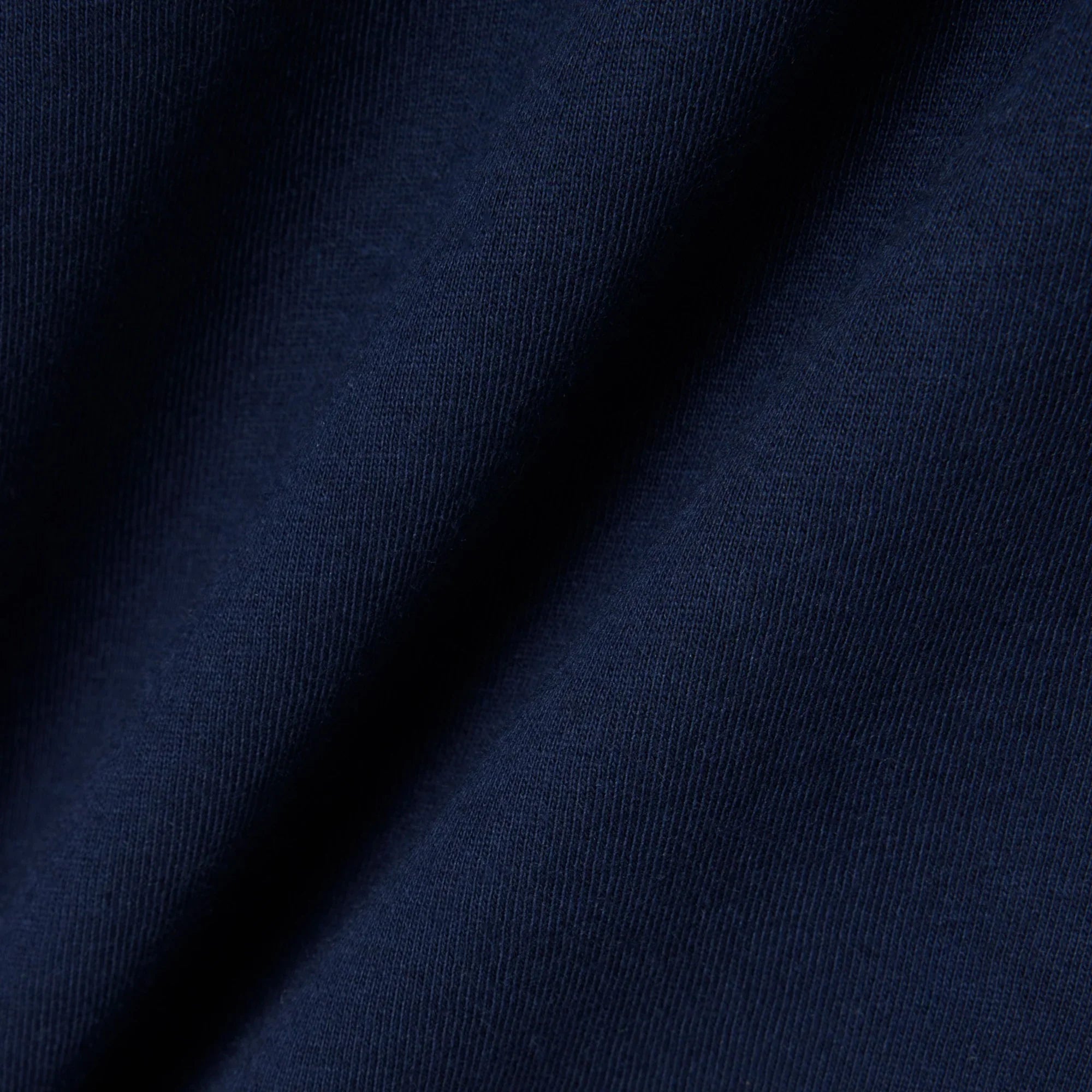 Dettaglio tessuto blu scuro, texture abbigliamento uomo donna, moda Made in Italy