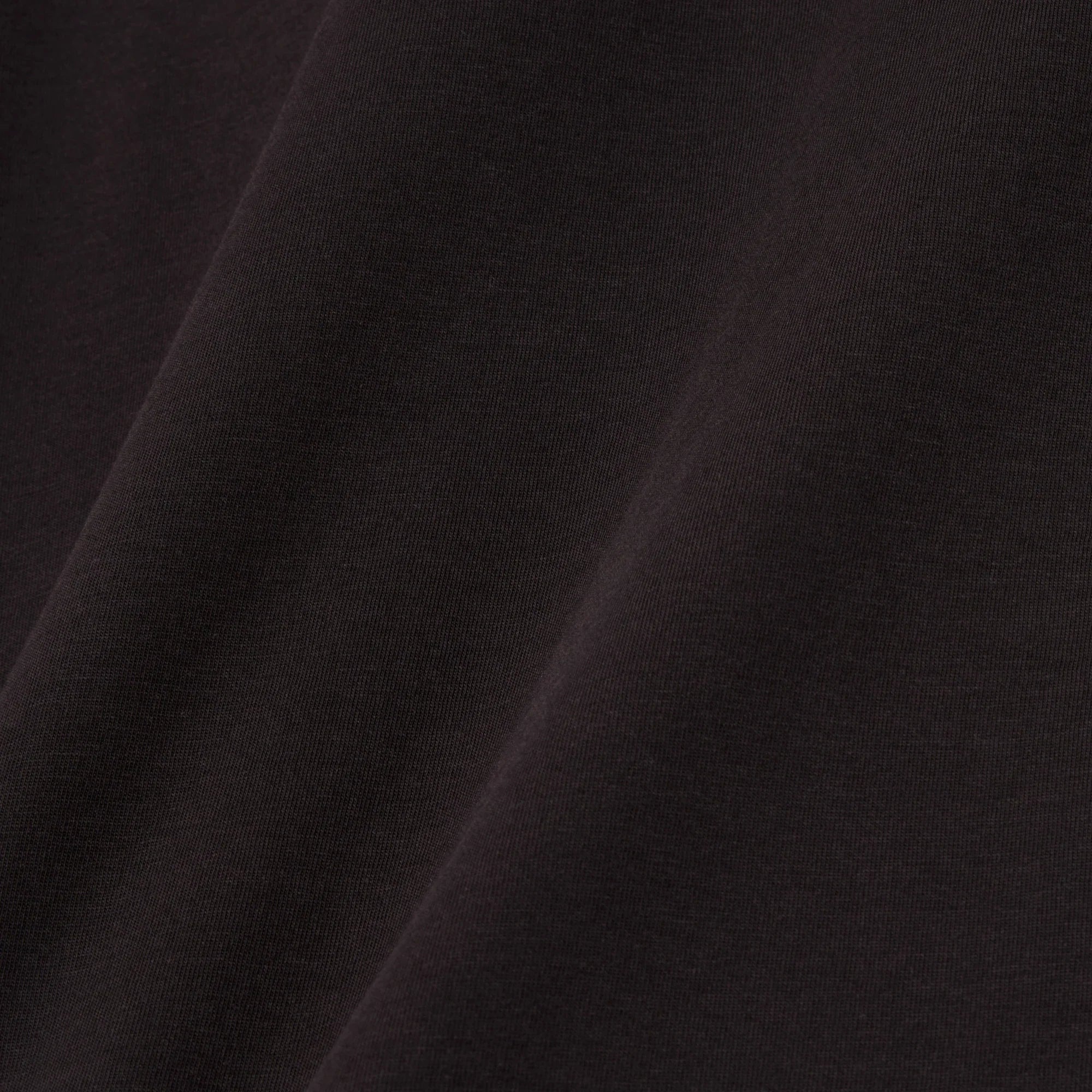 Dettaglio tessuto cotone nero abbigliamento uomo donna, texture liscia elegante