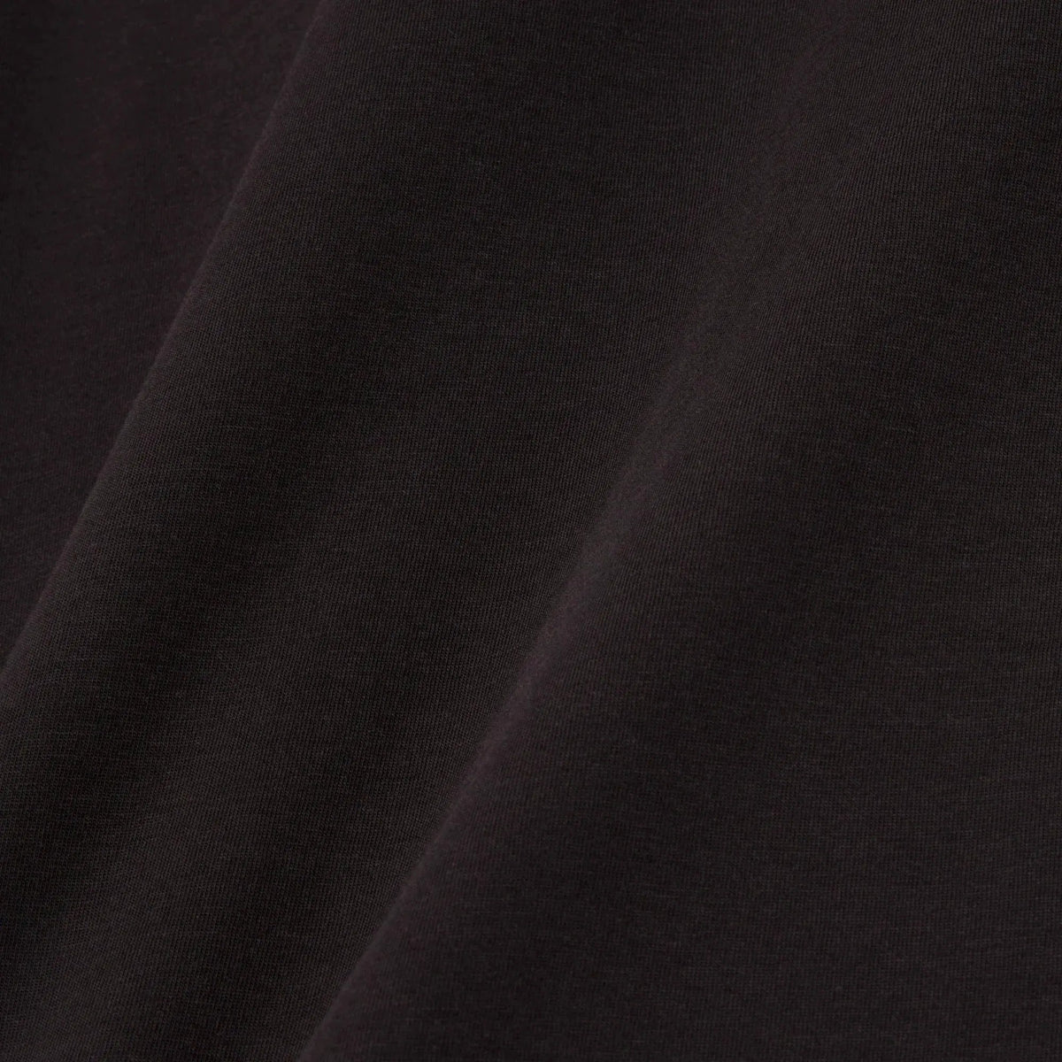 Dettaglio tessuto cotone nero abbigliamento uomo donna, texture liscia elegante