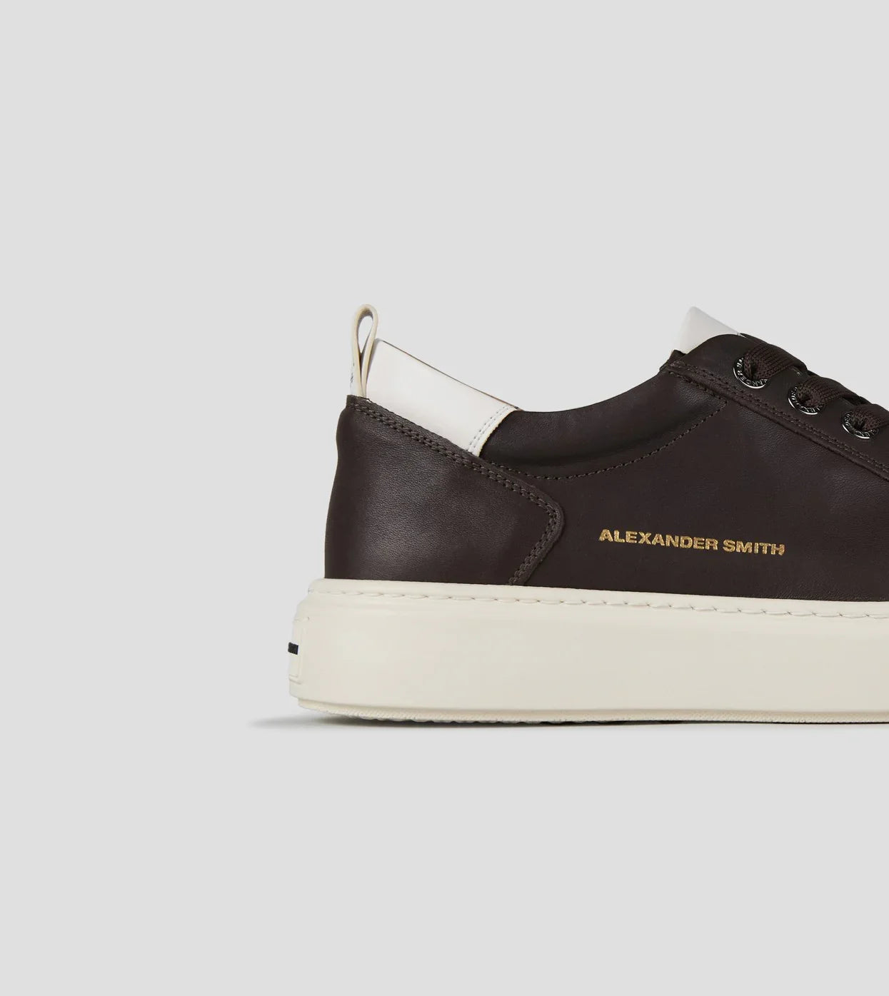 Sneaker uomo in pelle marrone scuro con dettagli bianchi e suola chiara, stile casual elegante