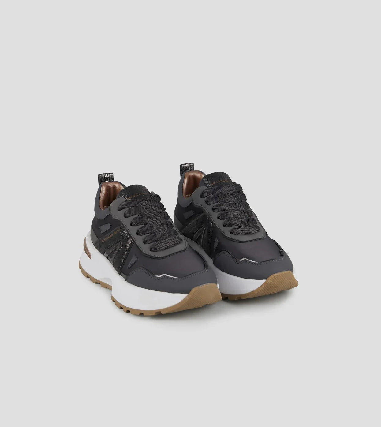 Sneakers donna nere con dettagli marroni, suola alta bianca e fondo beige, stile casual