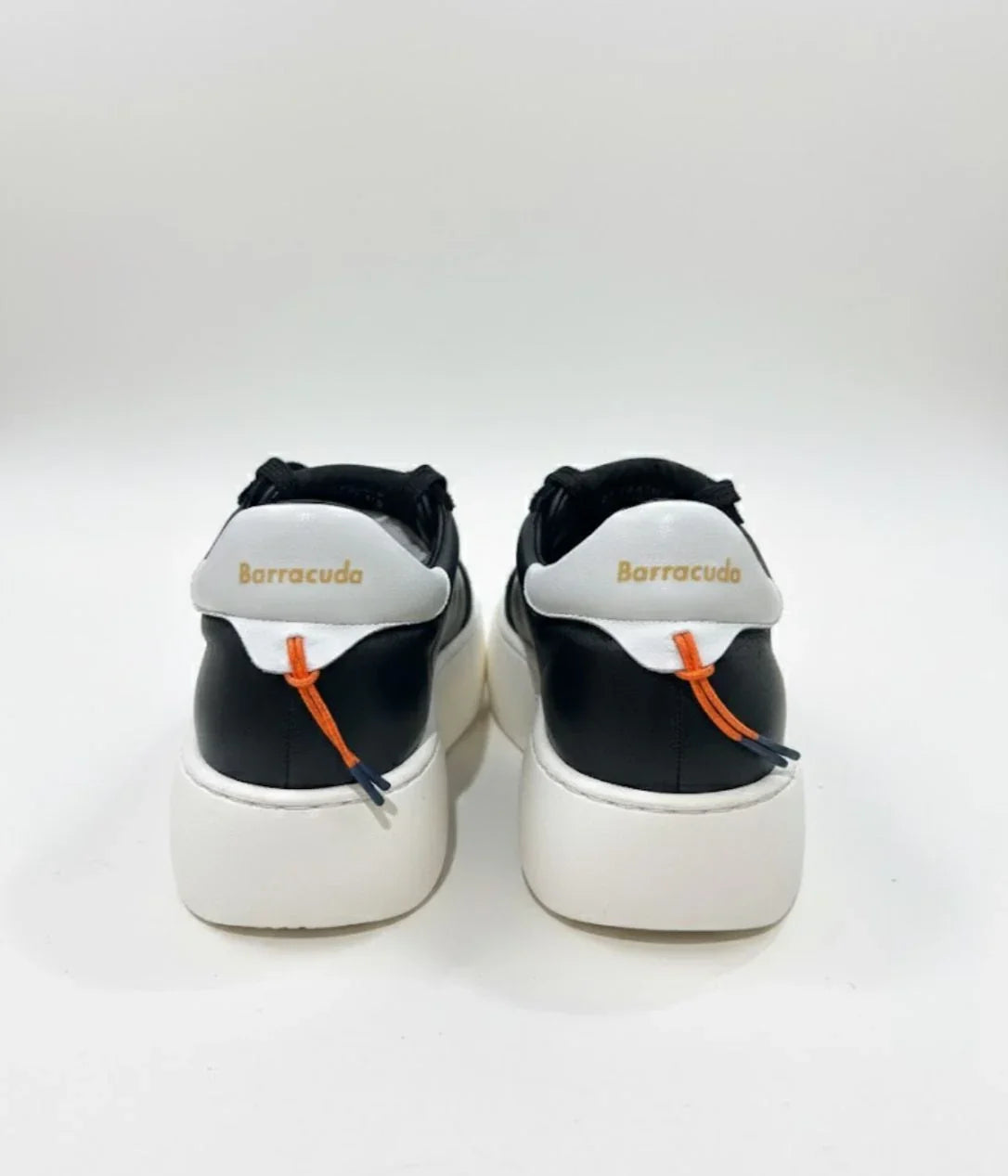 Sneaker uomo nera e bianca Barracuda con suola alta, dettaglio arancione sul tallone.