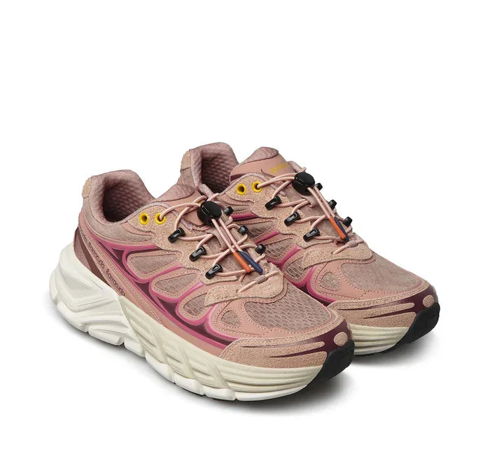 Sneaker rosa da donna con suola spessa bianca, dettagli gialli e laccio tecnico, stile sportivo
