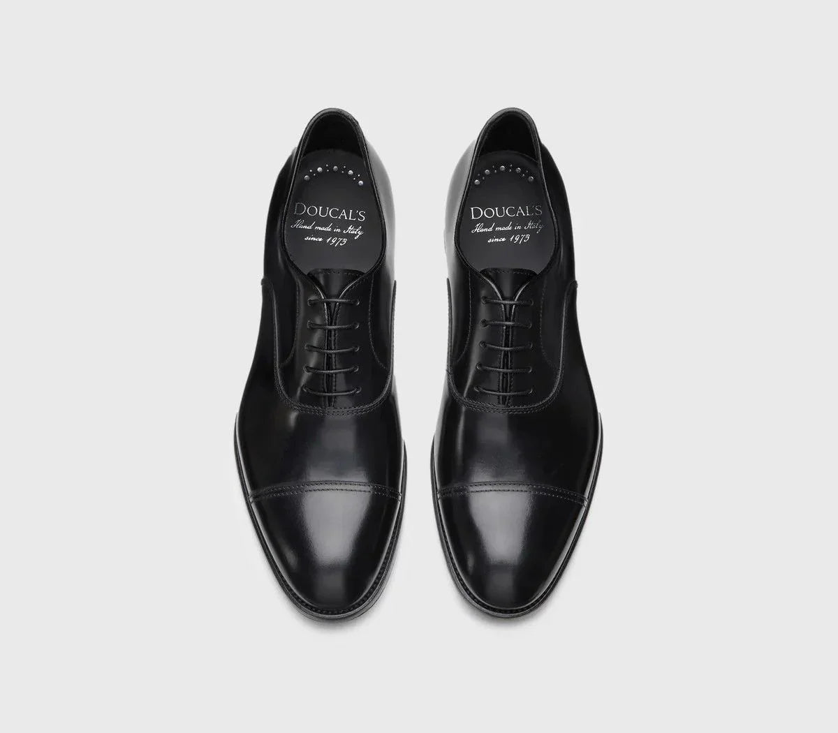 Scarpe Oxford nere da uomo in pelle lucida con punta decorata, stile elegante classico.