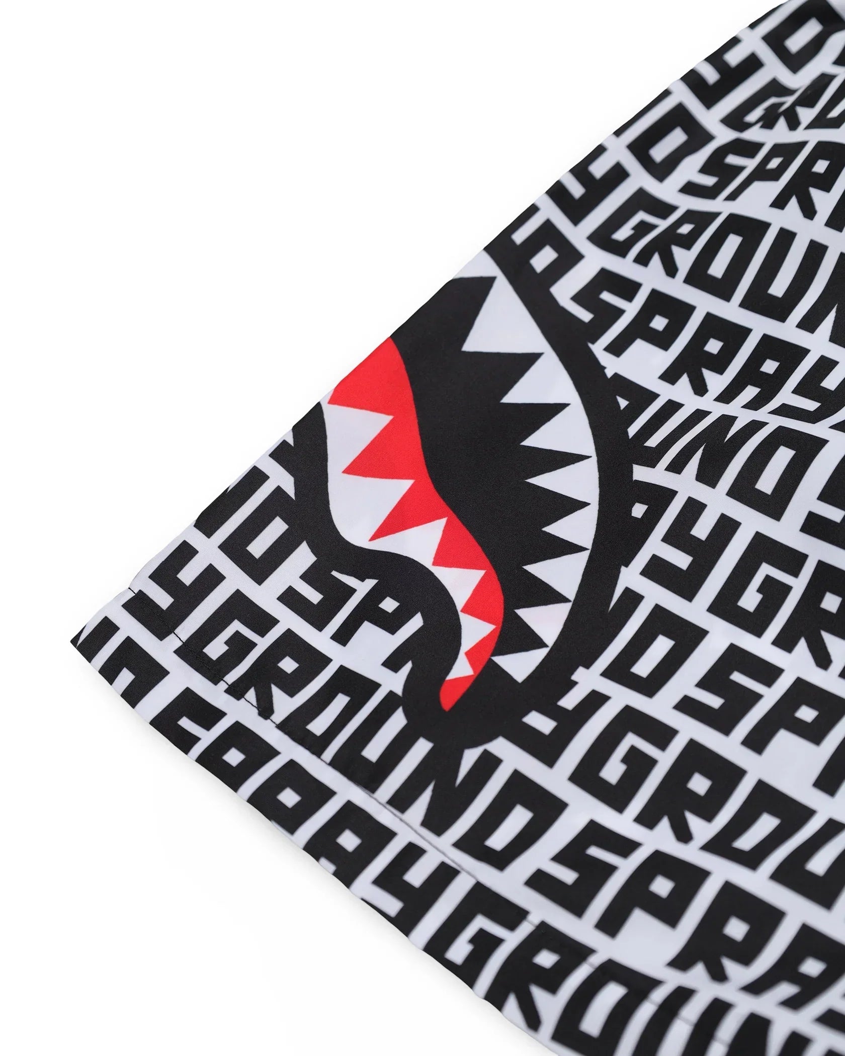 Dettaglio tessuto abbigliamento uomo con motivo grafico sprayground e stampa bocca squalo