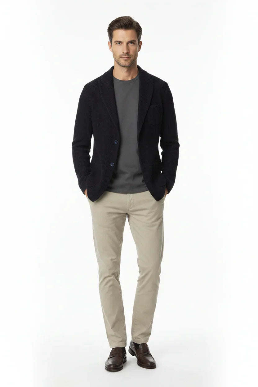 Modello uomo con giacca blu, maglia grigia, pantaloni beige e mocassini marroni eleganti