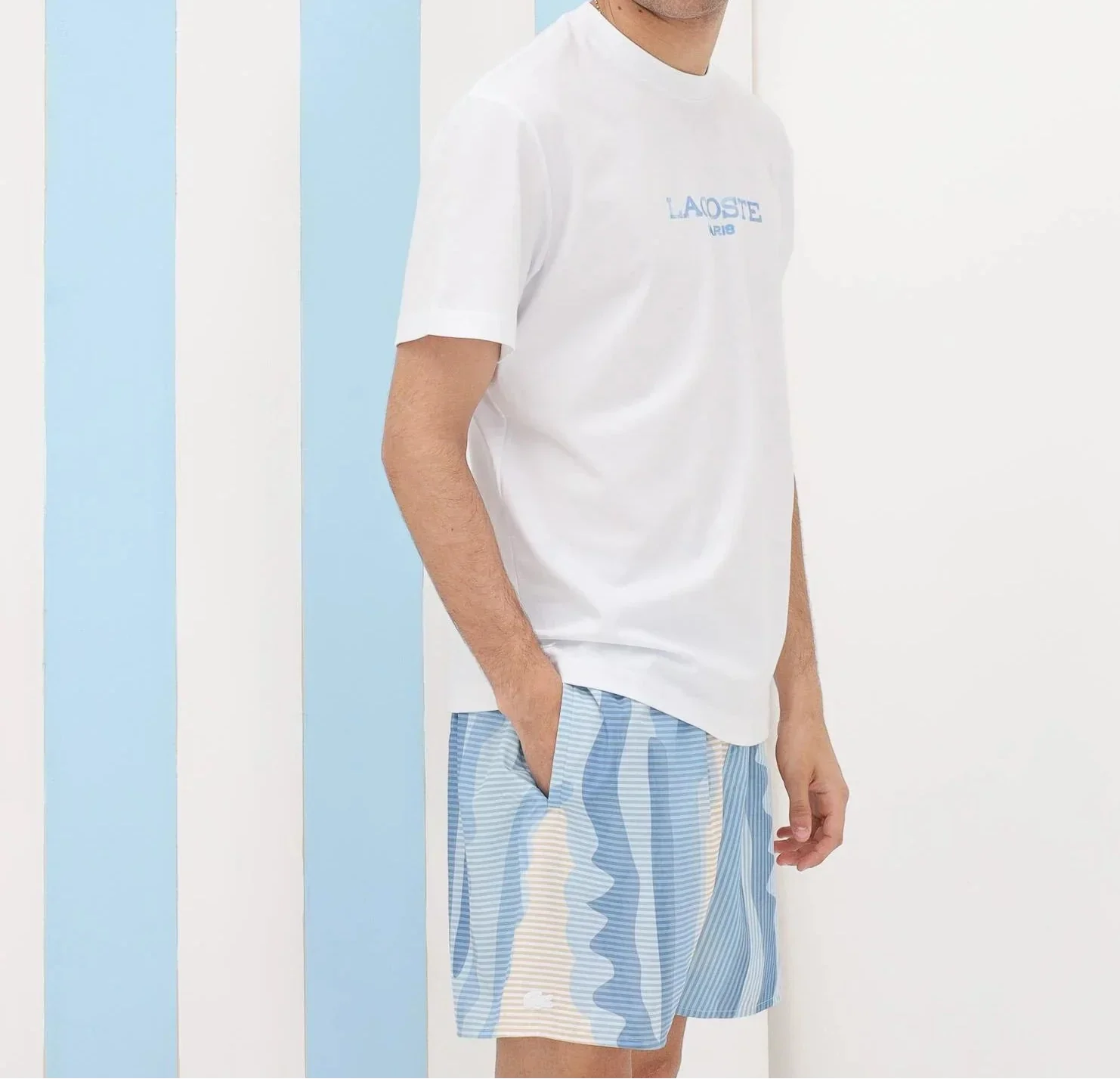 Uomo con t-shirt bianca e bermuda estivi a righe azzurre, moda uomo casual estiva