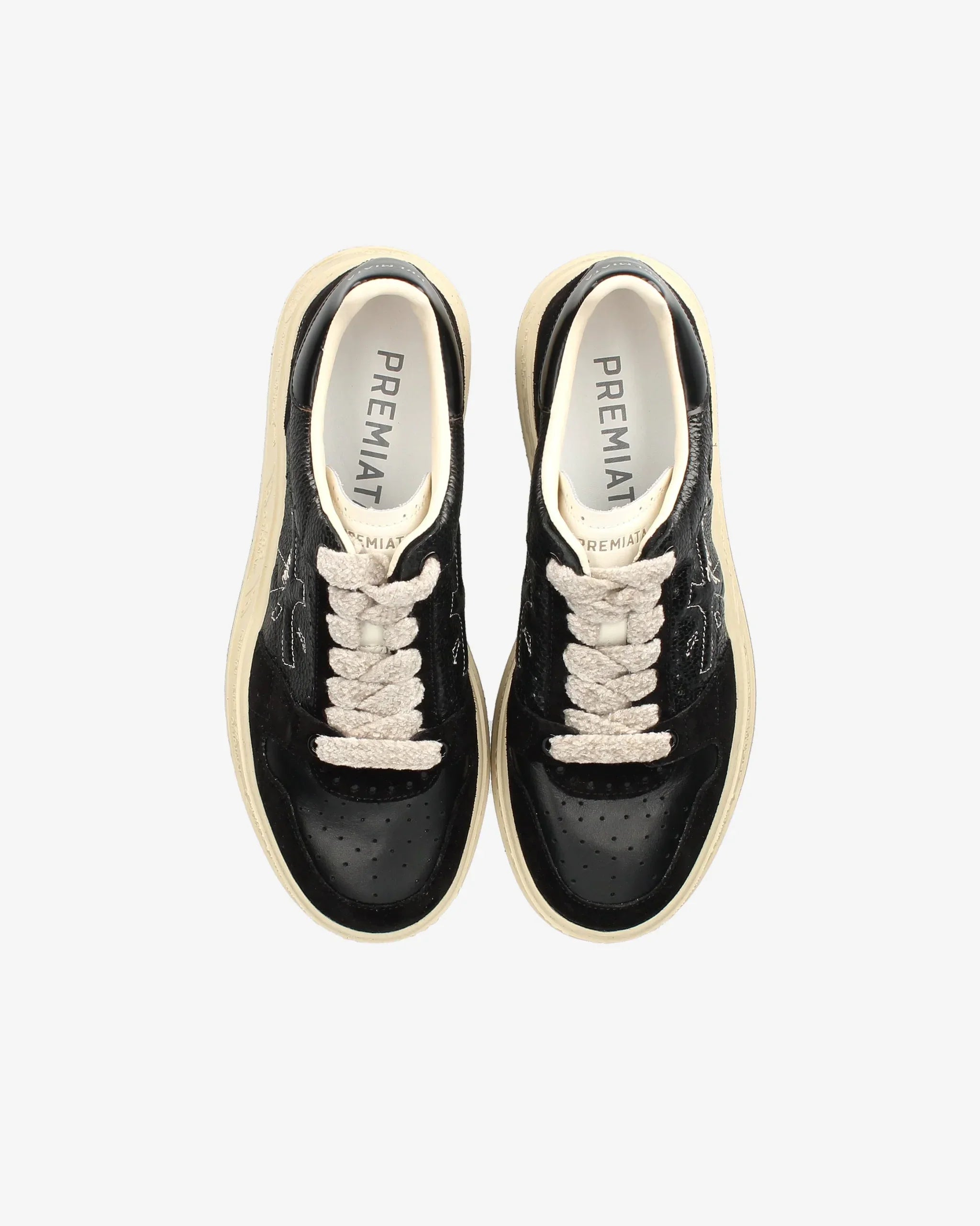 Sneakers nere in pelle con lacci chiari e suola beige, vista dall'alto, scarpa moda uomo donna