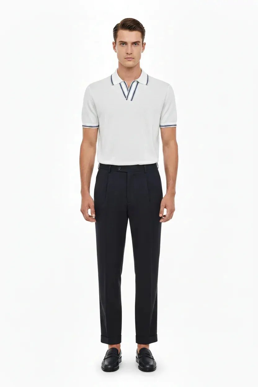 Modello uomo con polo bianca a maniche corte e pantaloni eleganti neri, look casual elegante