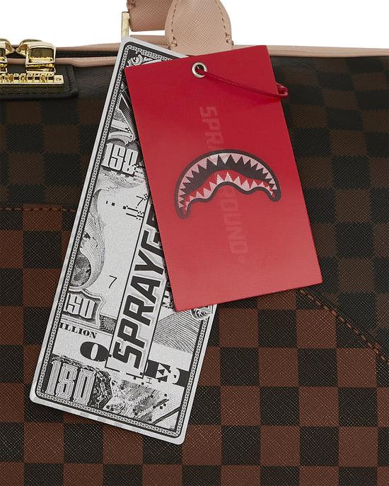 Dettaglio borsa a scacchi marrone con etichette Sprayground e chiusura dorata