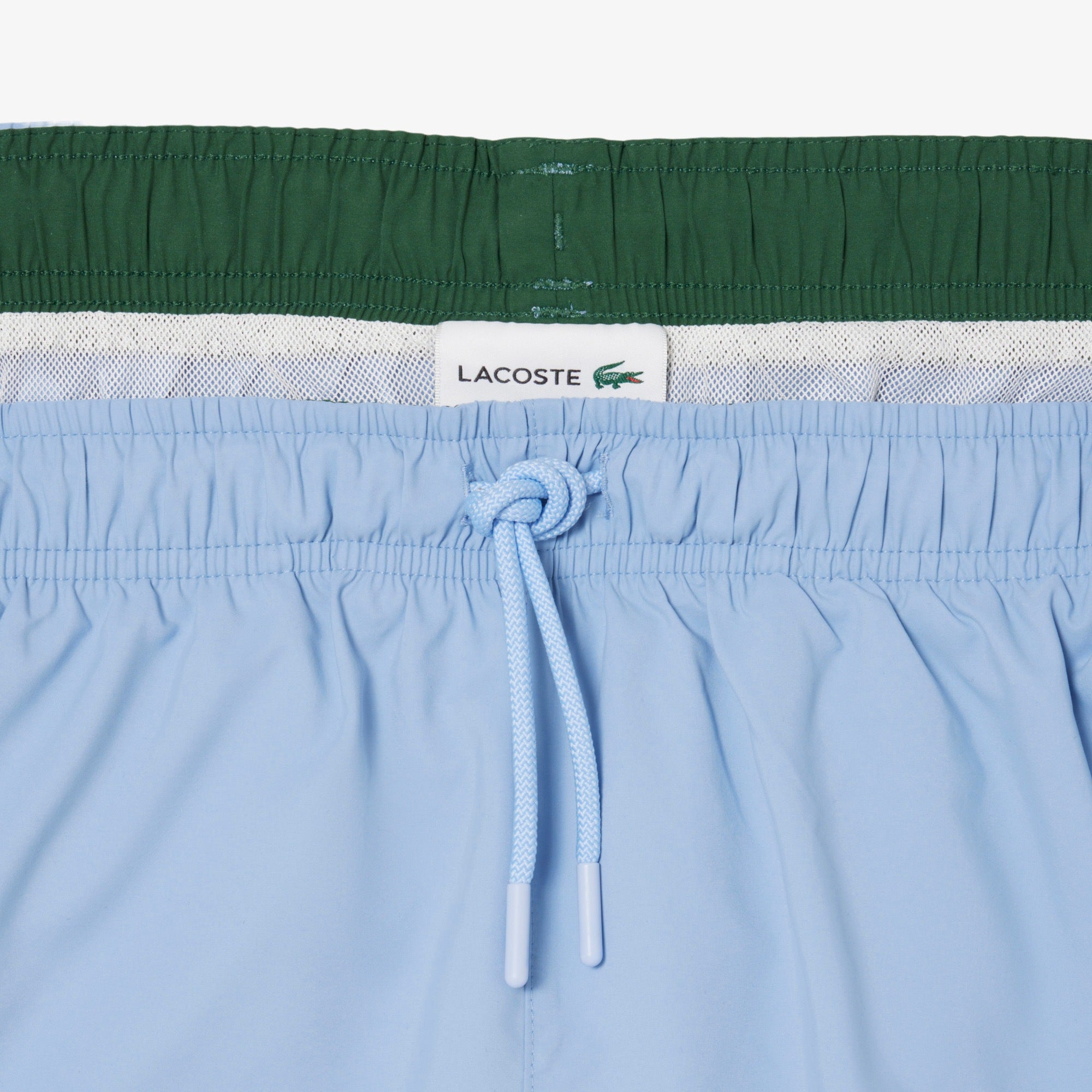 Costume da bagno LACOSTE MH6270 38I in tessuto quick-dry, con design sportivo e logo distintivo, vista frontale.