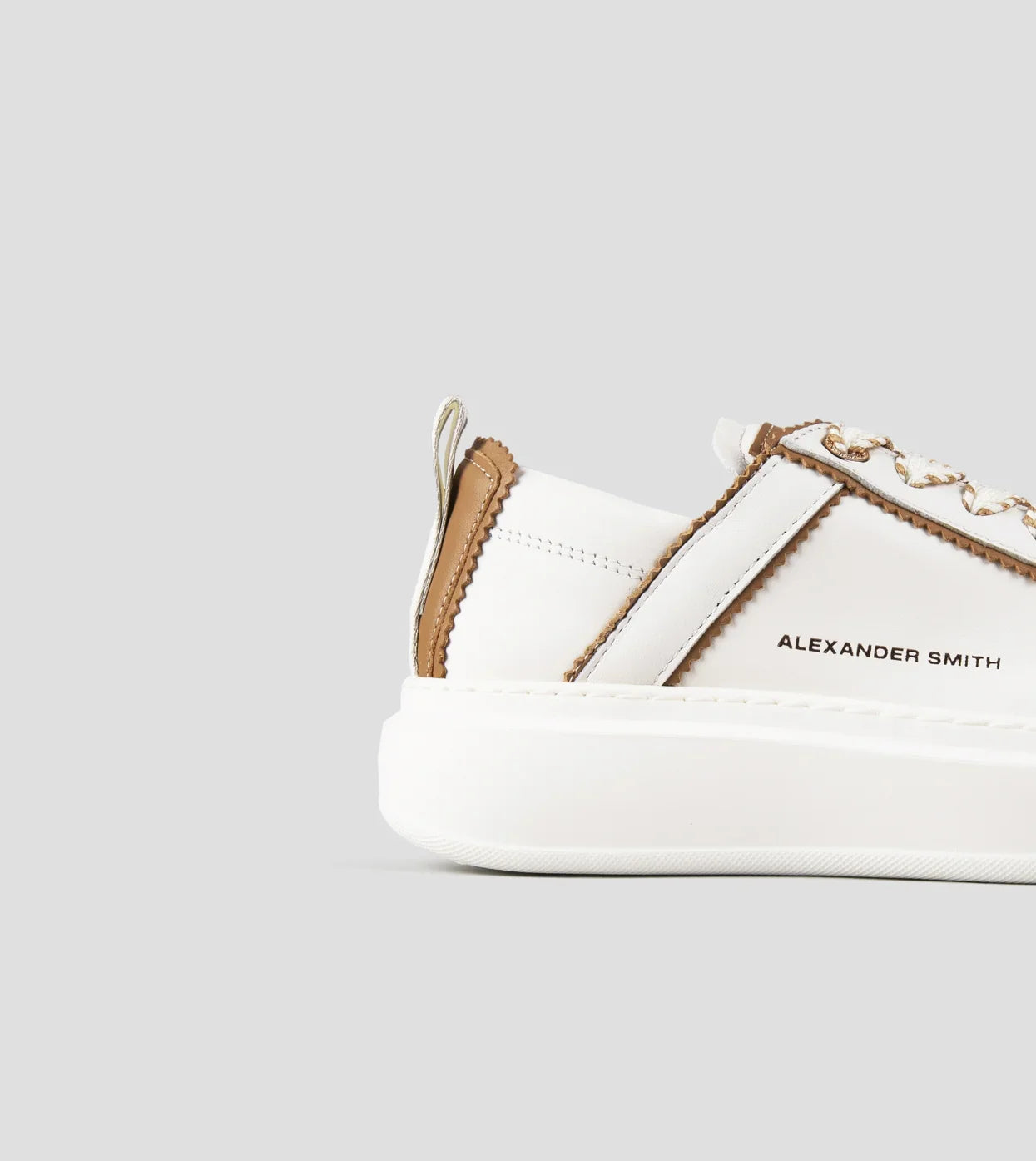 Sneaker donna in pelle bianca con dettagli marroni, suola spessa, stile moderno.